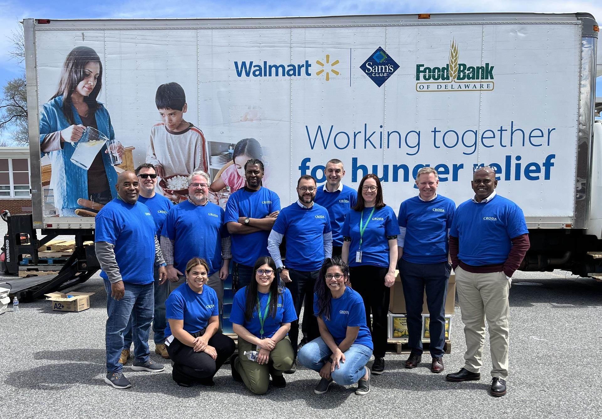 Croda employee volunteers pose in front of Food Bank of Delaware's truck at a Mobile Pantry event