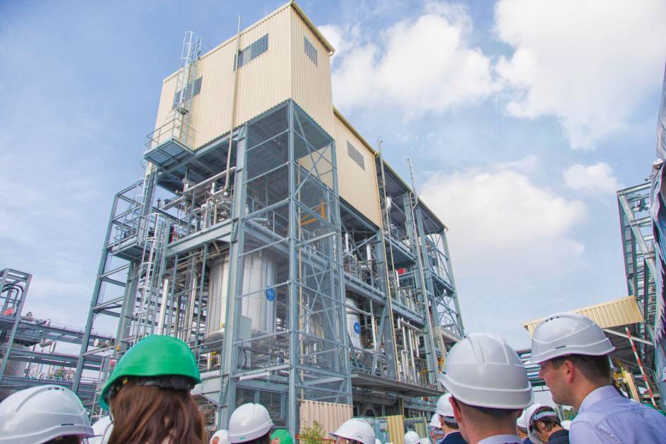 Employees with helmets on admiring new Croda building