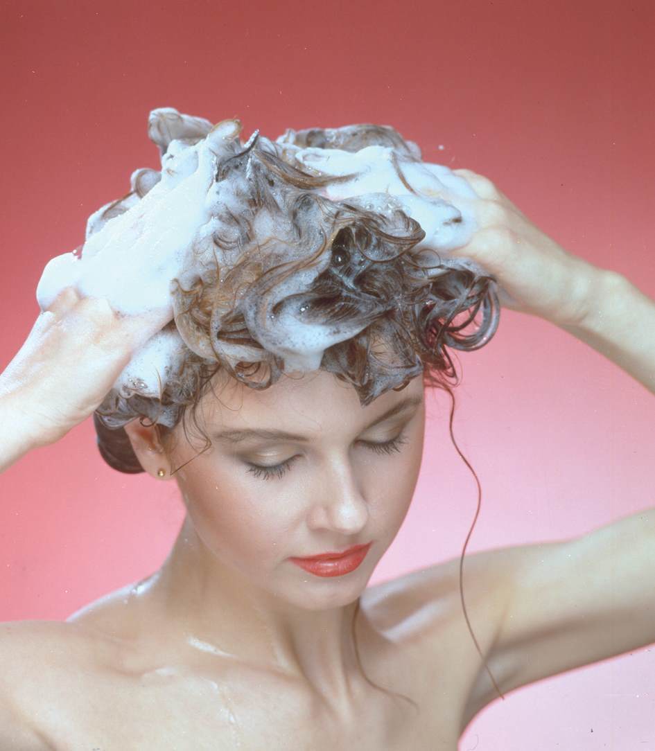Female washing hair with shampoo containing Crotein Q our first quarternised protein