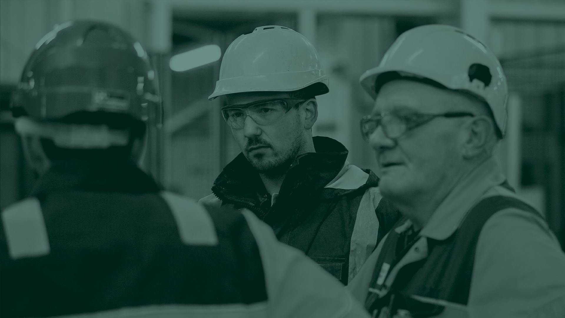 manufacturing employees with a green overlay