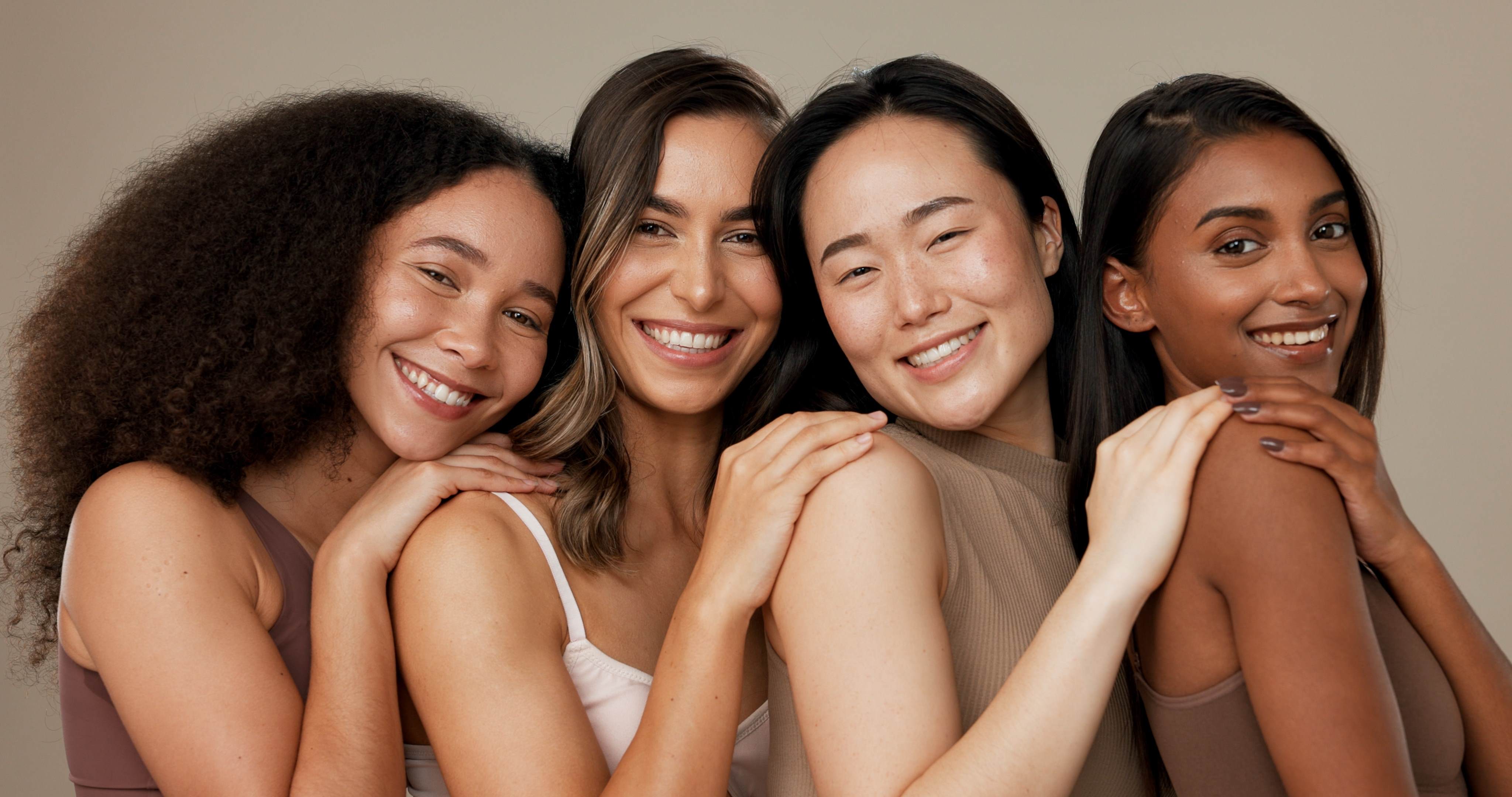 four ladies smiling with glowing skin