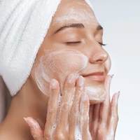 lady washing face and creating emulsification with product