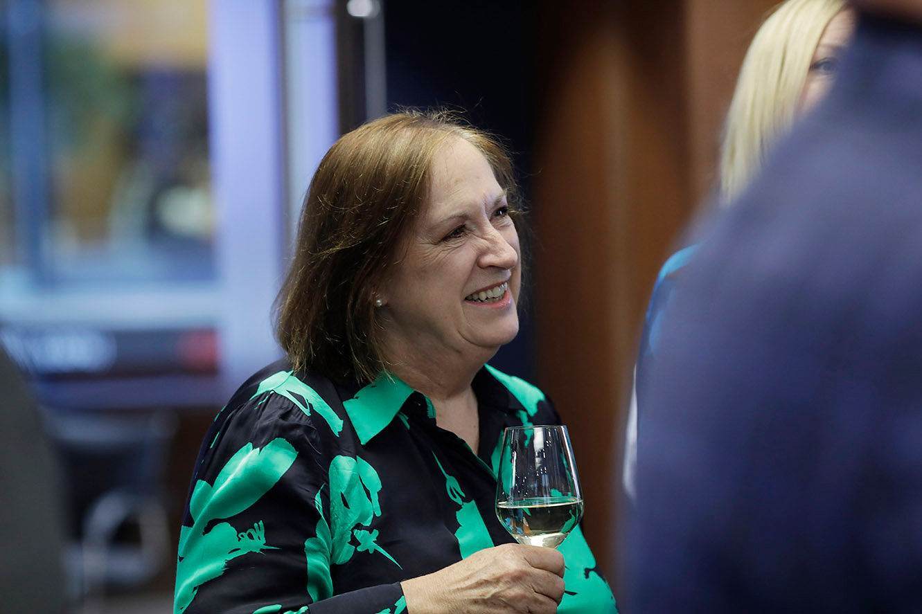 lady smiling at someone in corporate setting