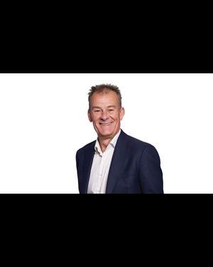 headshot of man wearing suit and tie