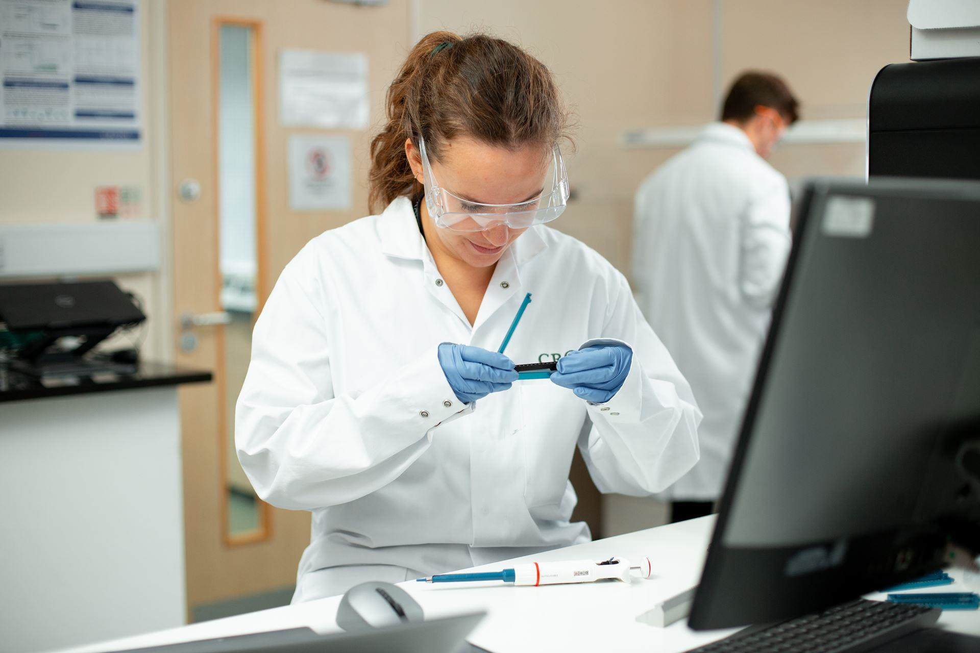 female scientist looking at laboratory experiment