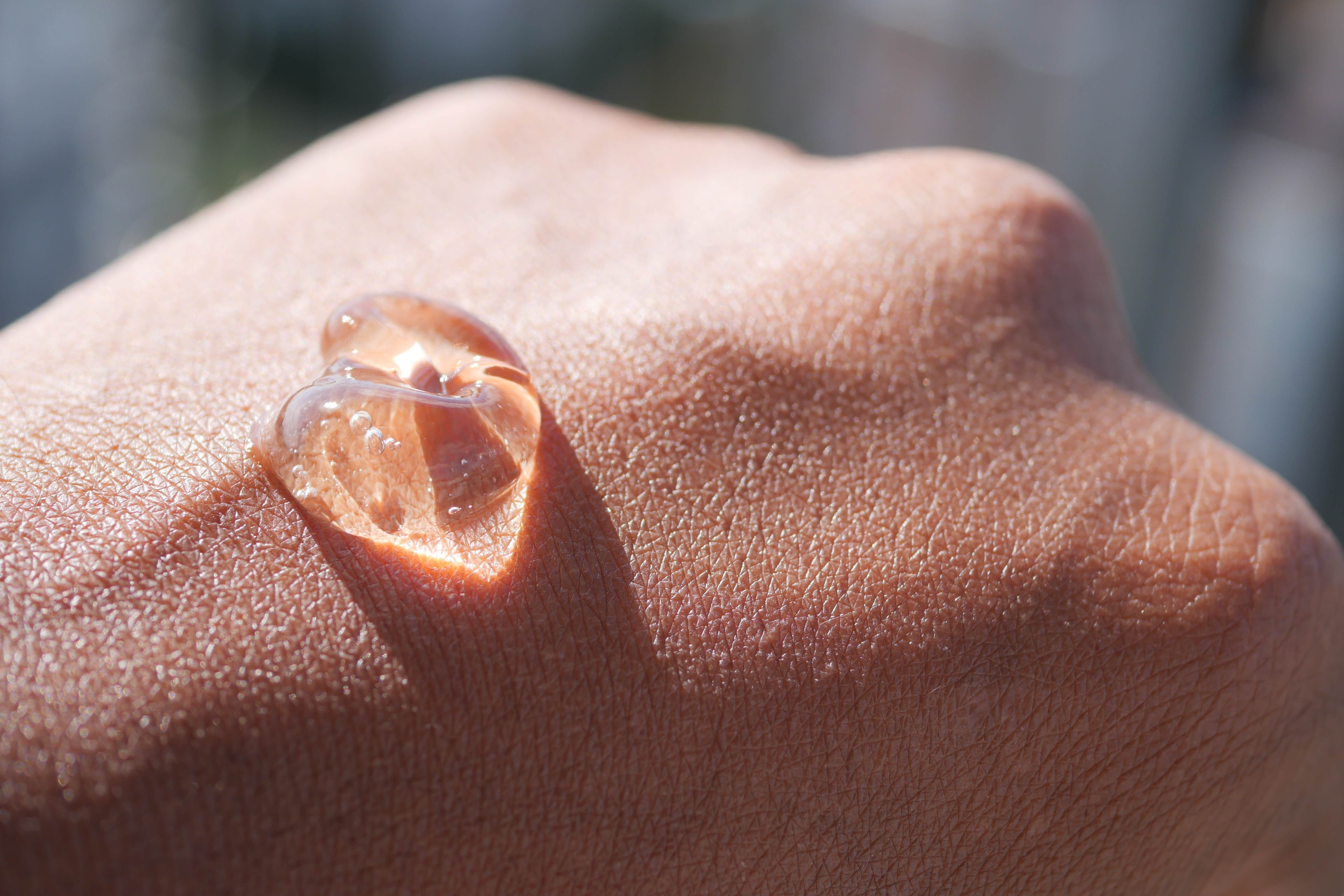 Aloe vera gel resting on hand under sunlight