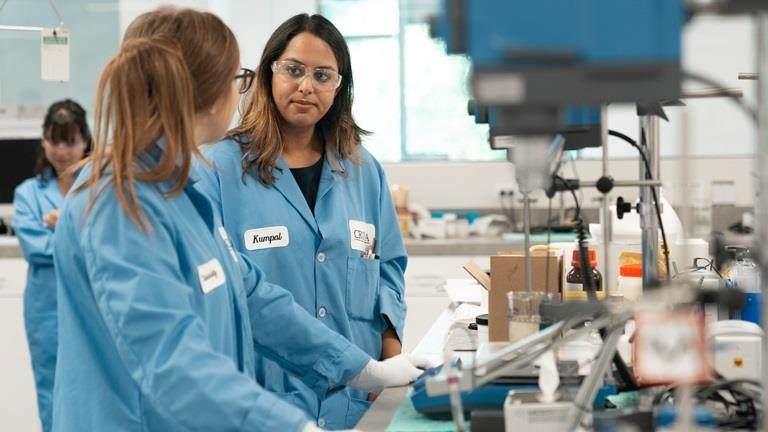 Two female Croda employees in laboratory wearing lab coats