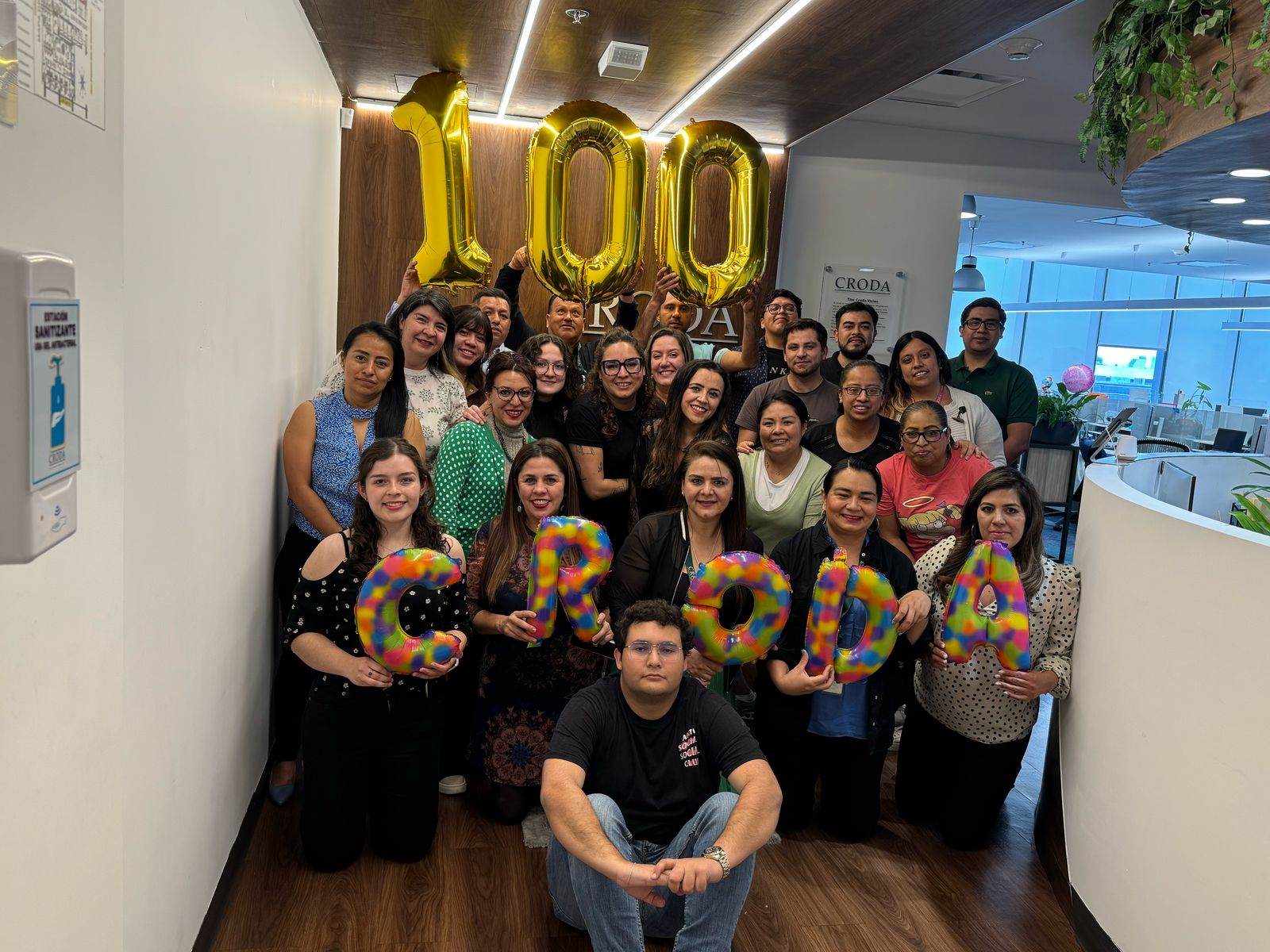 employees celebrating with 100