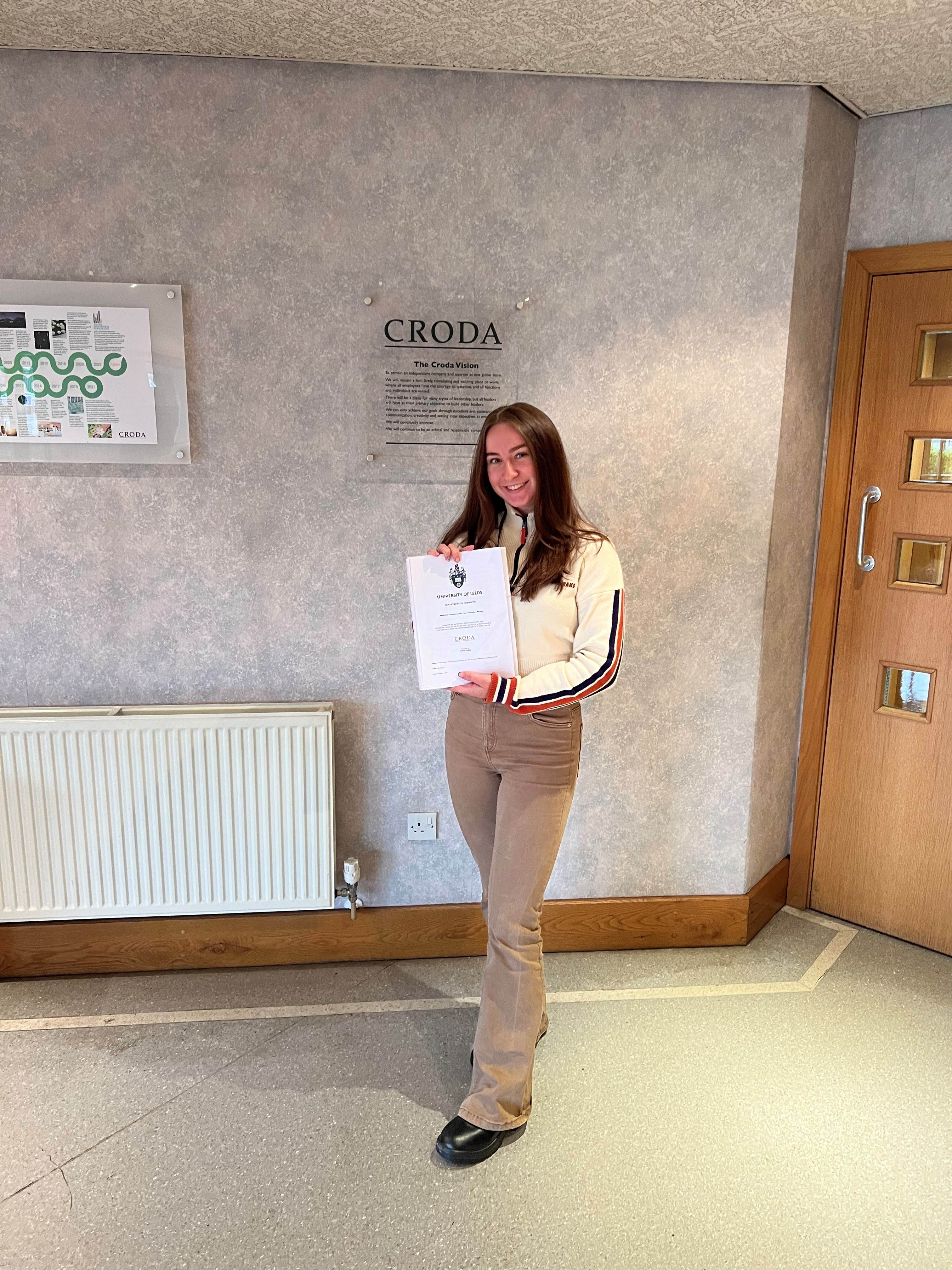 employee holding certificate