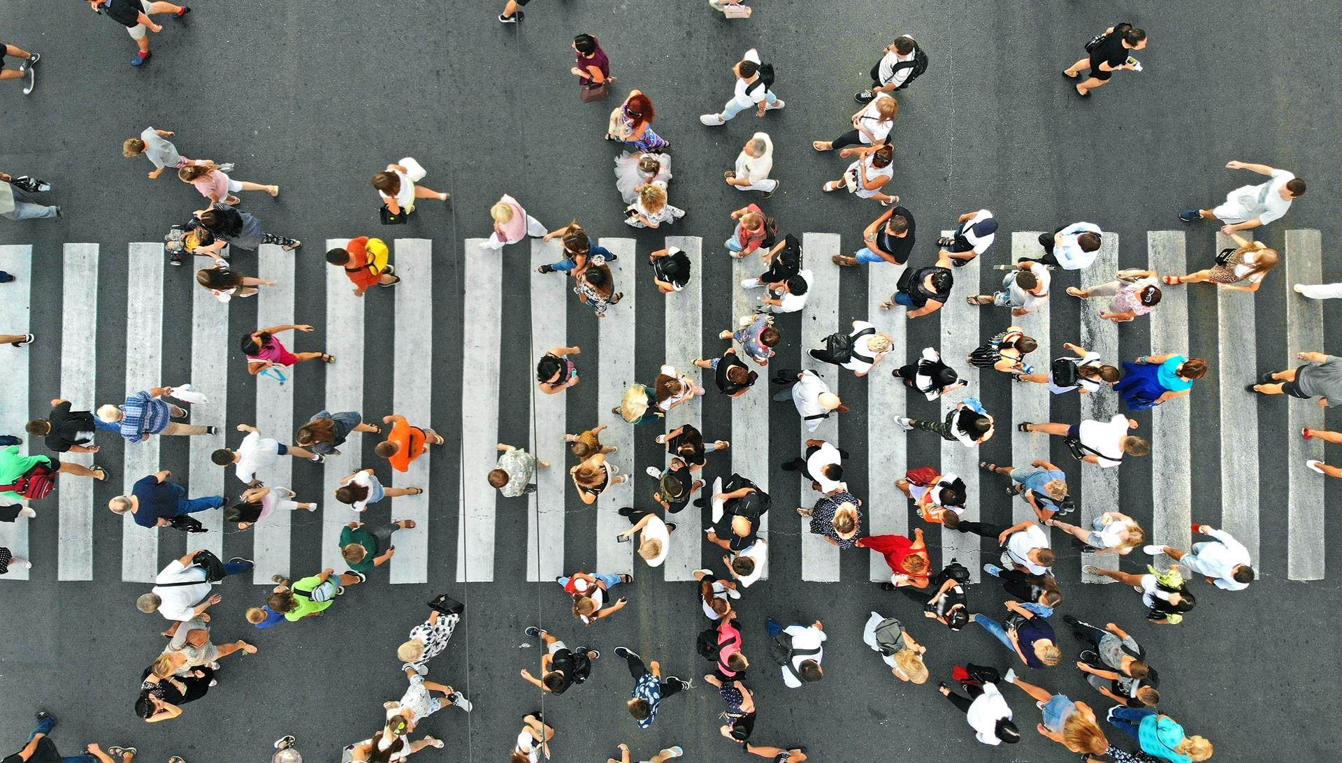People walking across a busy street