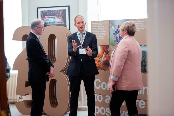 sustainability officer with visitors discussing sustainability targets for 2030