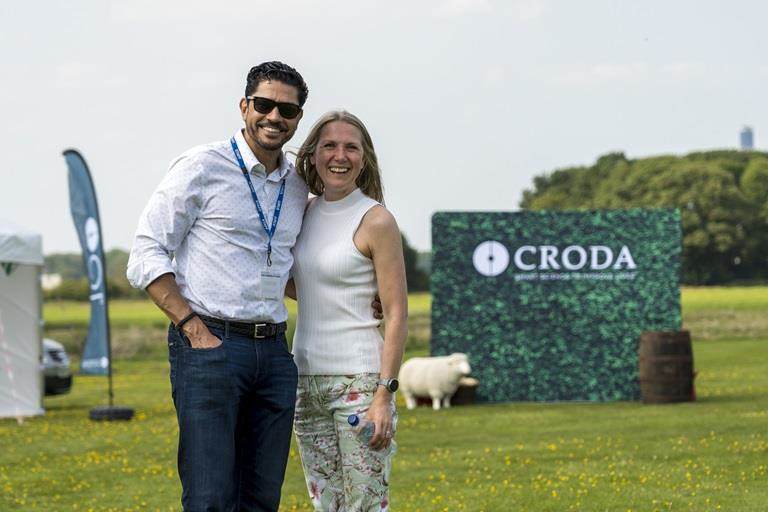 Croda employees stood in front of croda logo