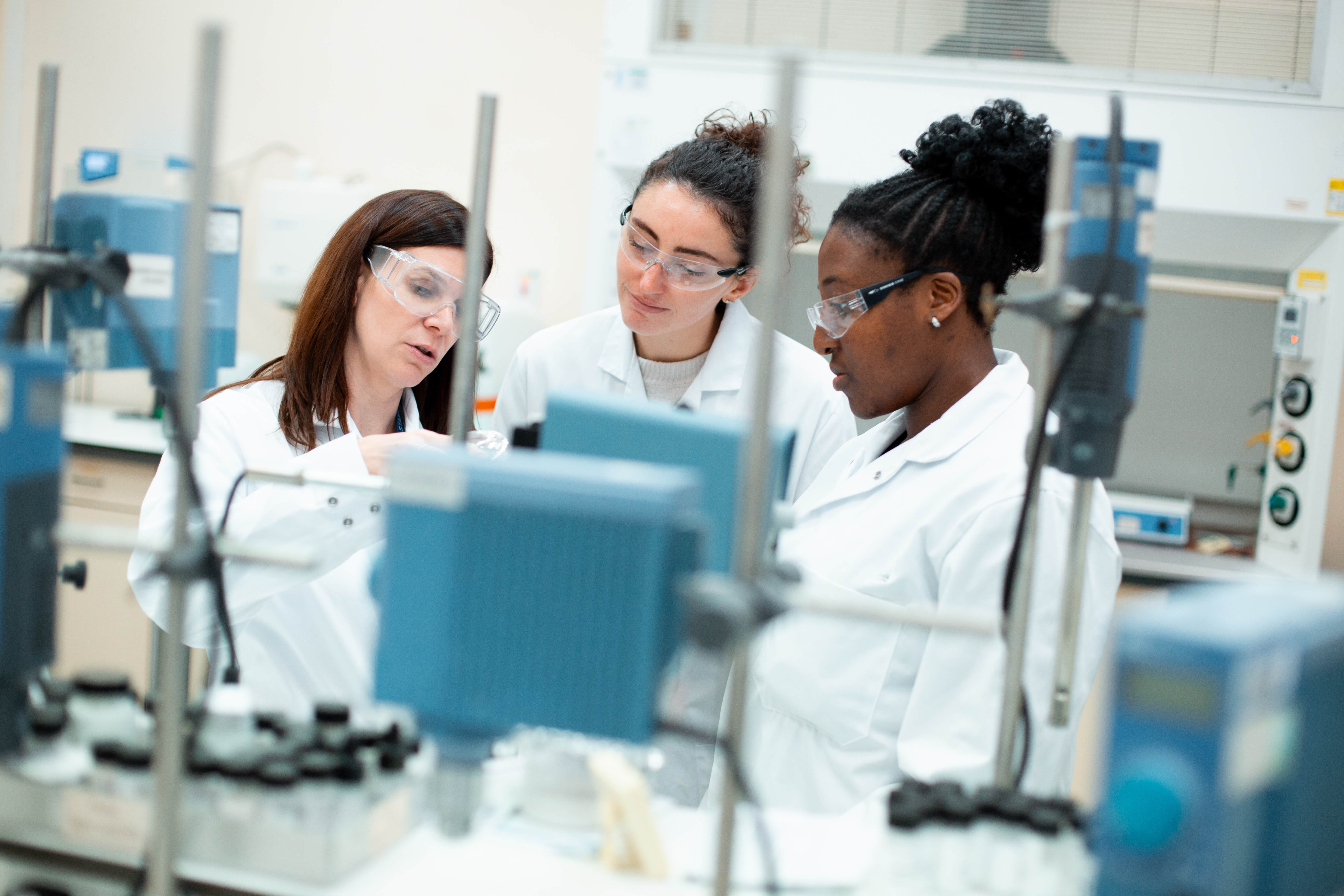 three scientists working together in a laboratory
