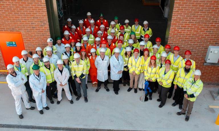 employees in safety clothing stood together