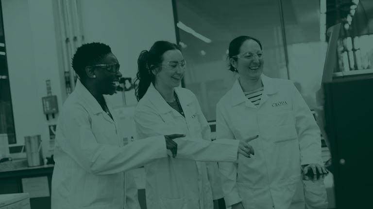 Green tone image of three female scientists in a laboratory