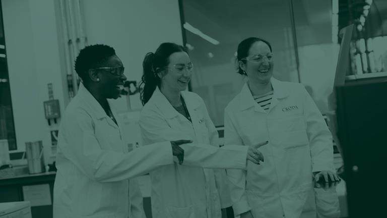 Green tone image of three female scientists in a laboratory