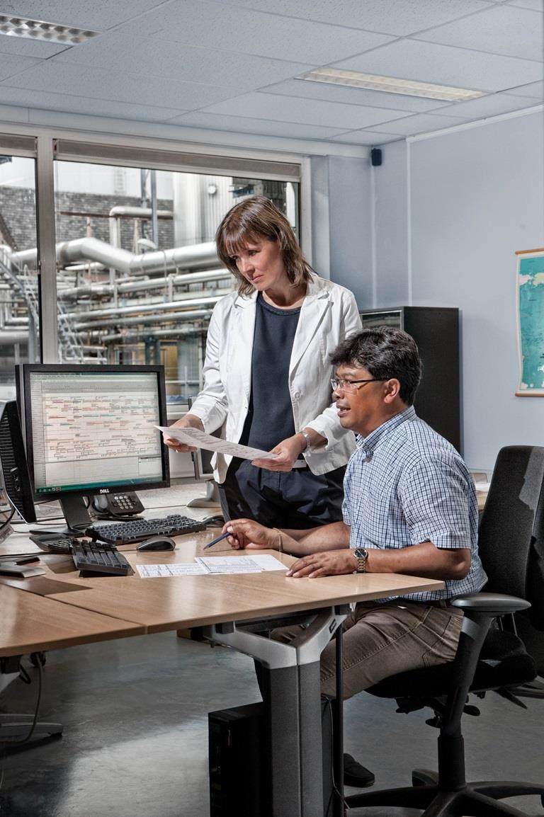 workers sat at desk looking at computers