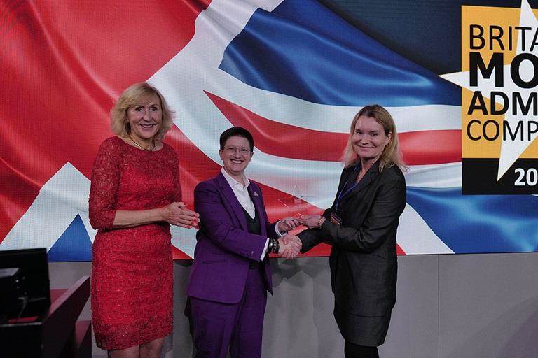 three women being presented an award