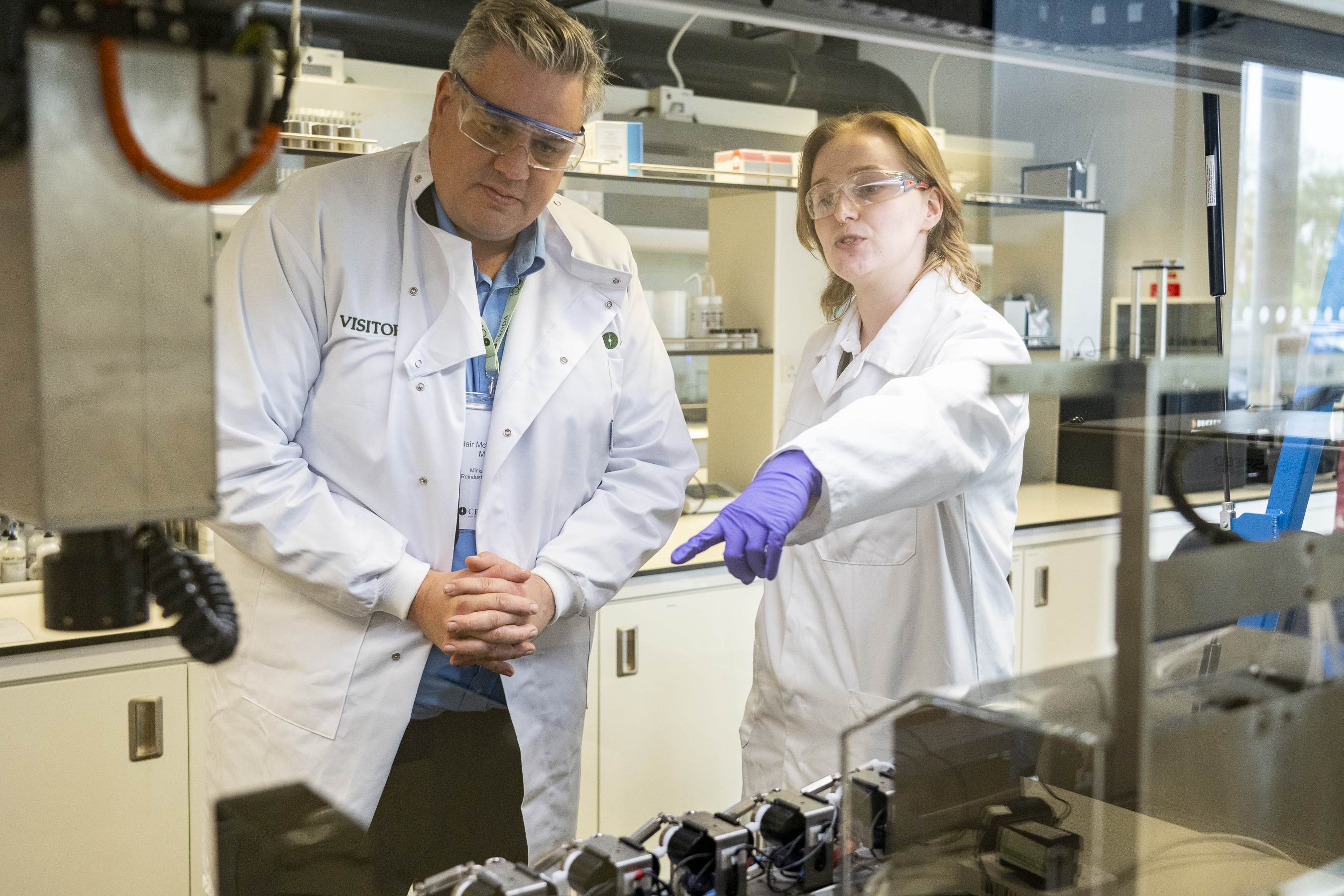 minister and science technician in a lab