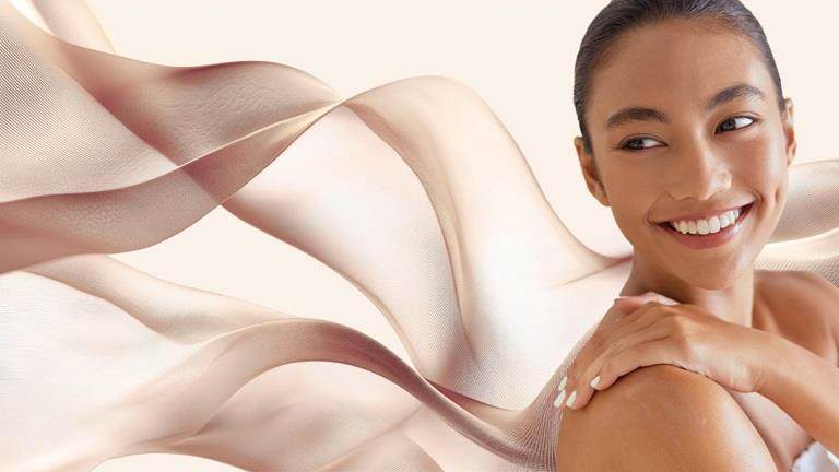 lady smiling with flowing fabric behind her