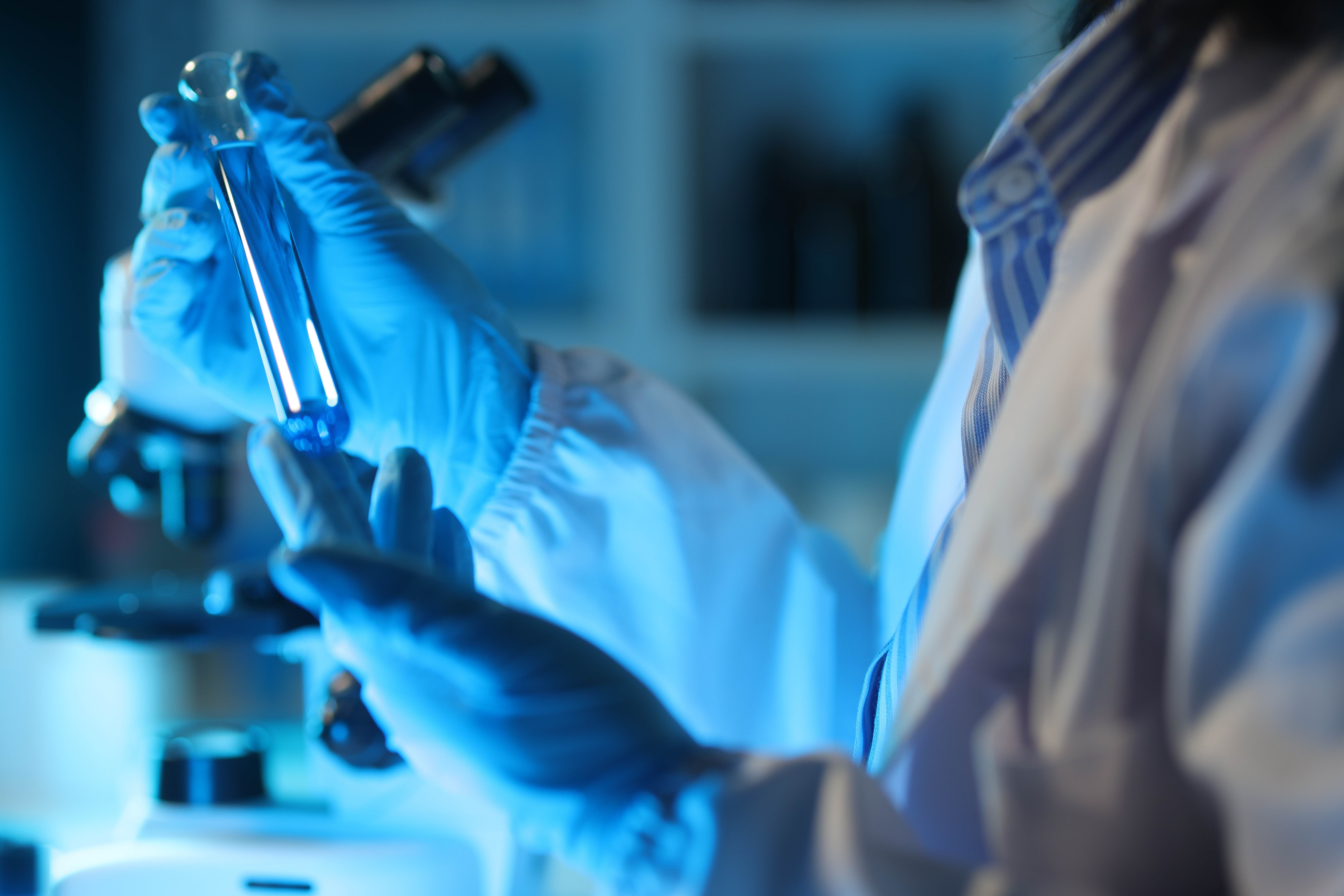 Medical scientist analysing test tube