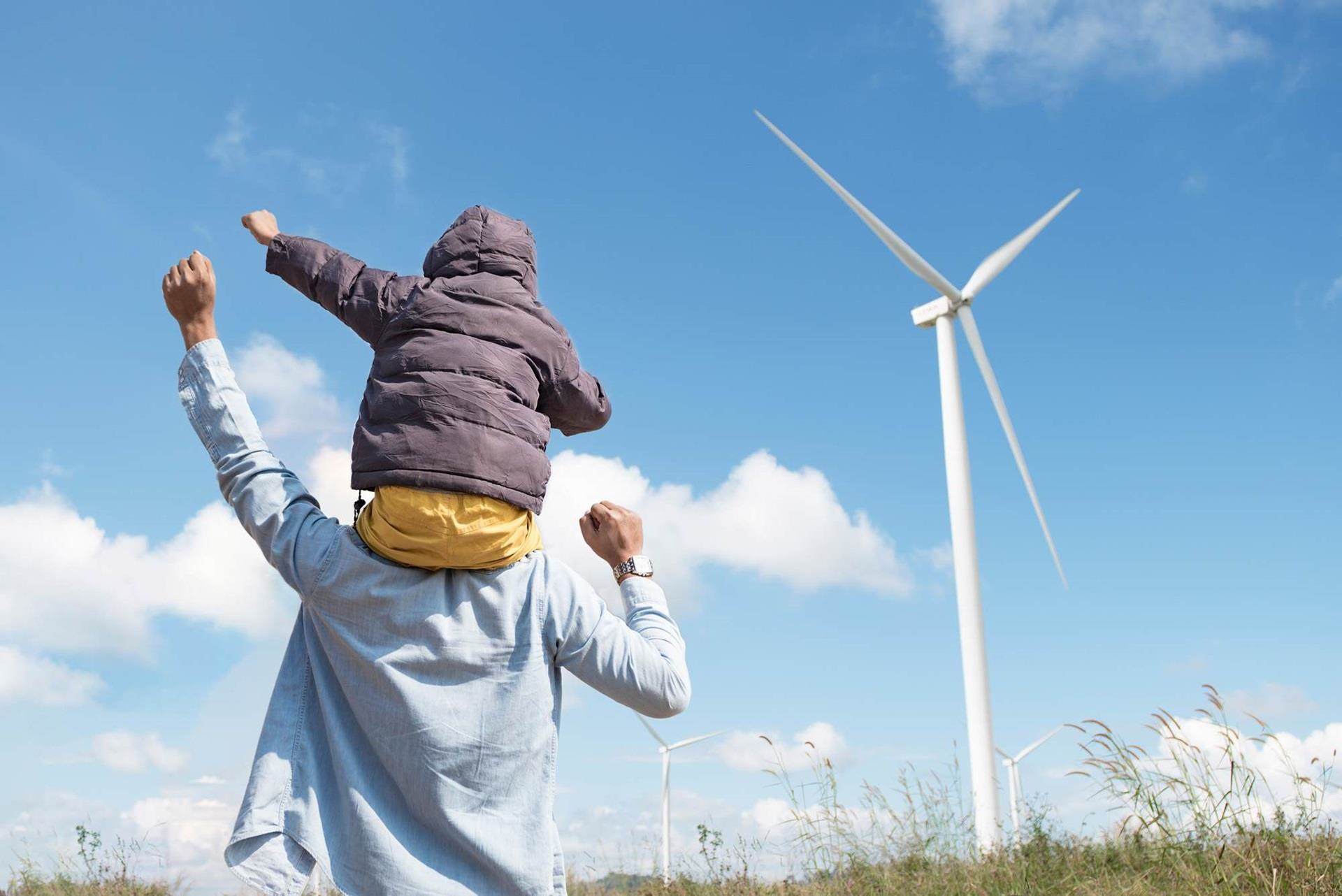people in front of wind turbine