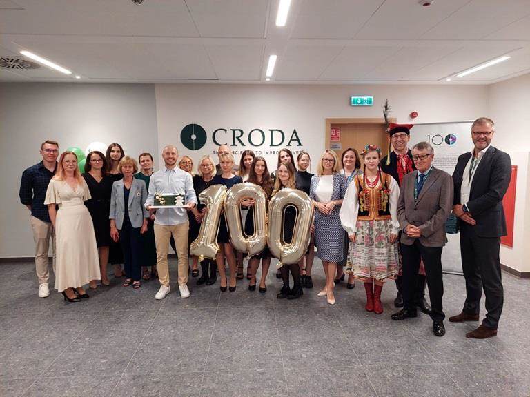 Croda employees standing together with 100 balloons