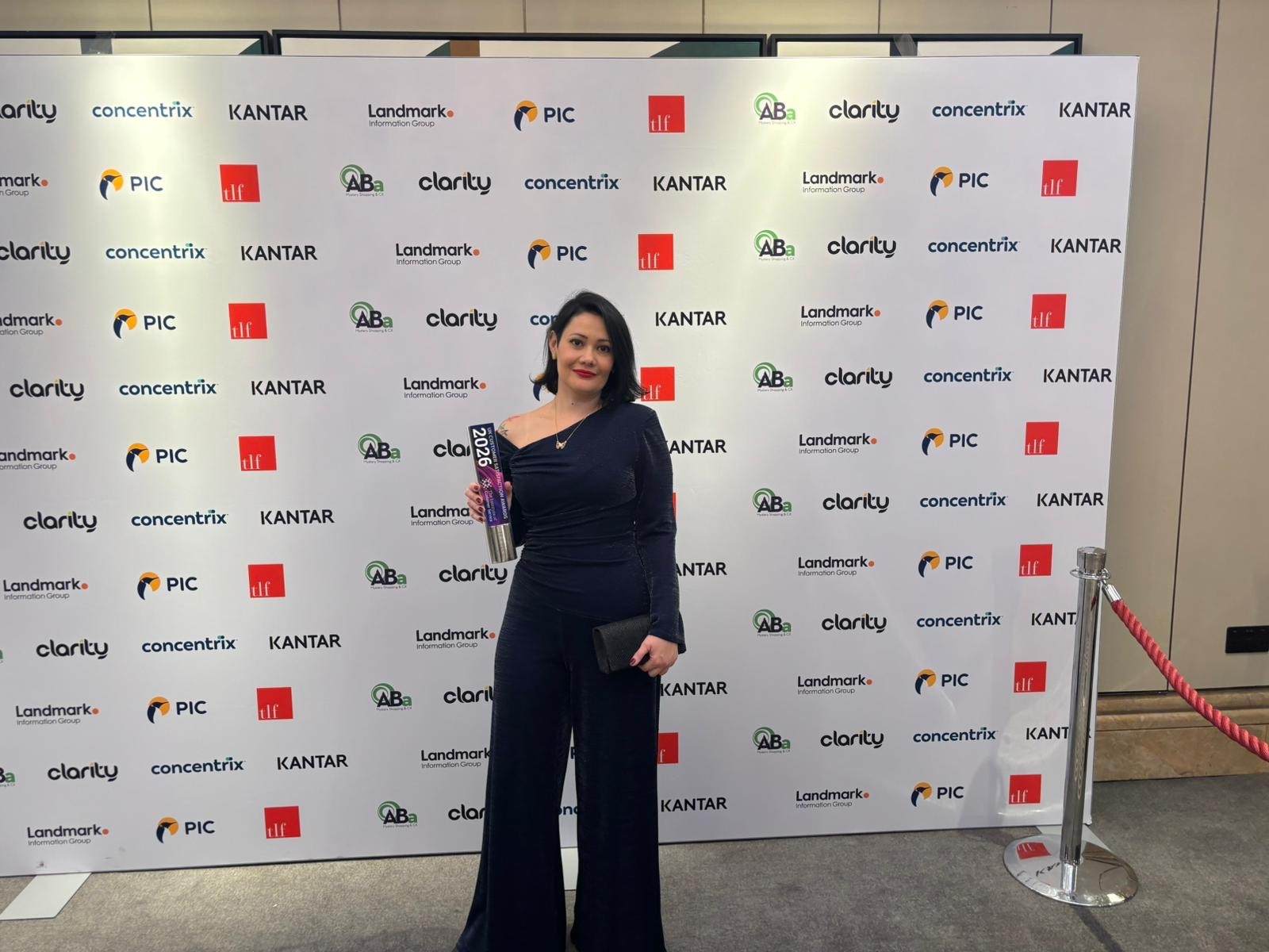 lady holding trophy for customer service award